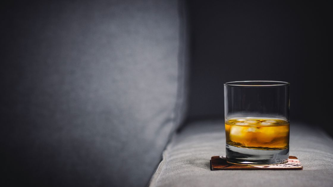 Glass of Whiskey on a Minimalist Couch